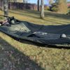 Person resting inside waterproof sleeping bag featuring hypothermia check openings for injury and temperature monitoring