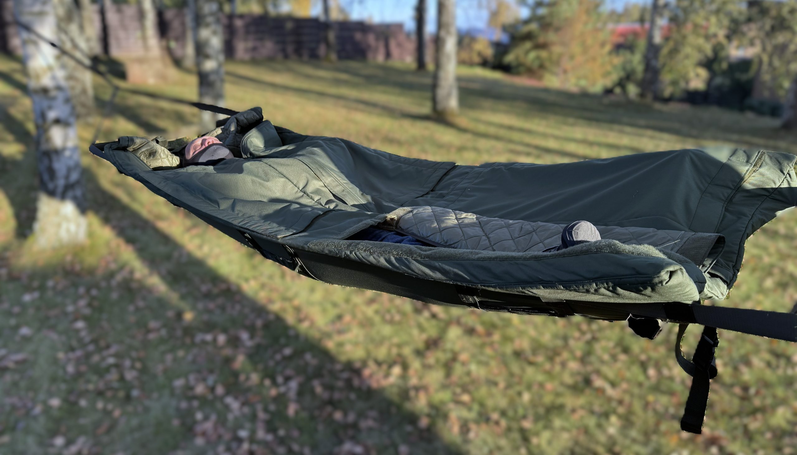 Multifunctional waterproof tactical sleeping bag that converts into a stretcher, hypothermic blanket, or hammock—ideal for military, rescue, and survival use.